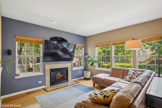 6068 Halloran Ln, Hoffman Estates, IL 60192 - living room featuring baseboards, a glass covered fireplace, and wood finished floors
