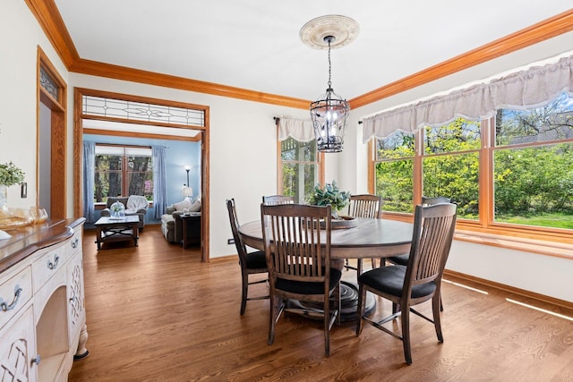 2905 Rose Ave, Mchenry, IL 60050 - dining area featuring crown molding, wood finished floors, baseboards, plenty of natural light, and a chandelier