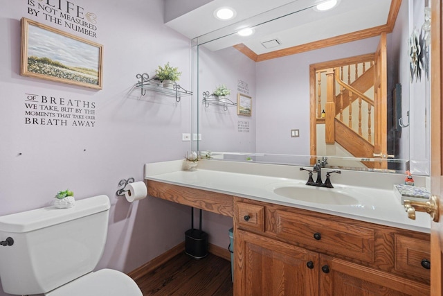 2905 Rose Ave, Mchenry, IL 60050 - half bath featuring toilet, vanity, wood finished floors, baseboards, and ornamental molding