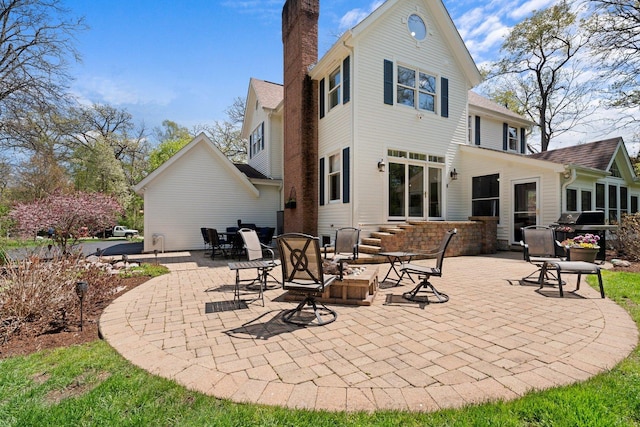 2905 Rose Ave, Mchenry, IL 60050 - back of house featuring a chimney and a patio