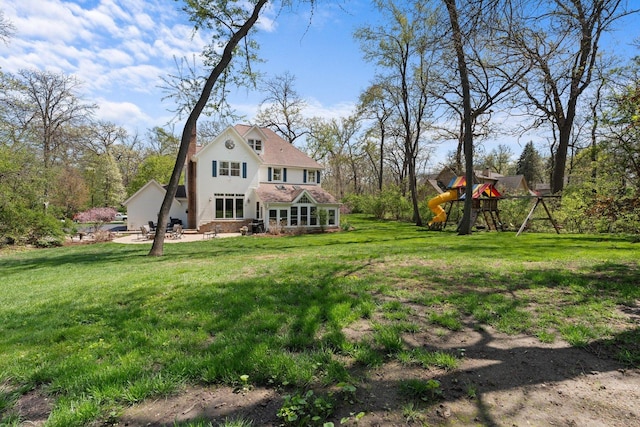 2905 Rose Ave, Mchenry, IL 60050 - rear view of property featuring a playground and a lawn