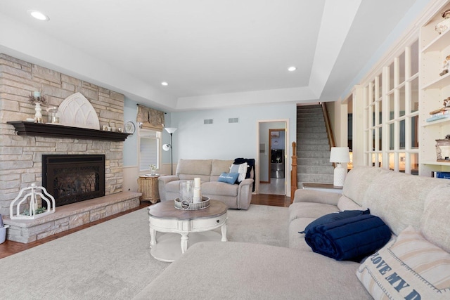 2905 Rose Ave, Mchenry, IL 60050 - living area featuring stairs, wood finished floors, a fireplace, recessed lighting, and a tray ceiling