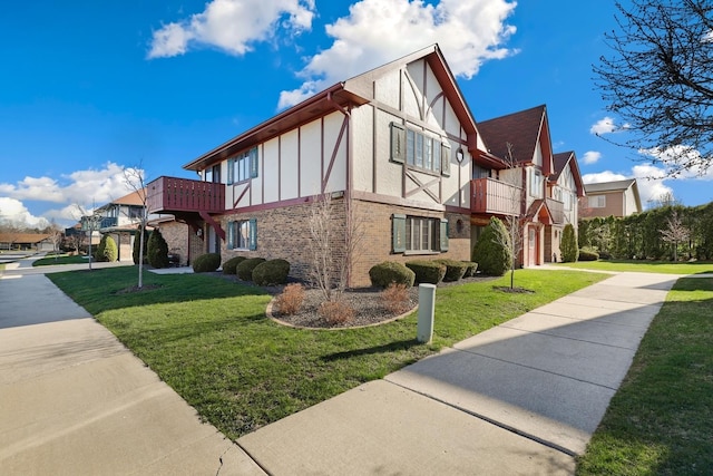 11545 Autobahn Dr E Unit 101, Palos Park, IL 60464 - view of side of property featuring a balcony, brick siding, and a lawn