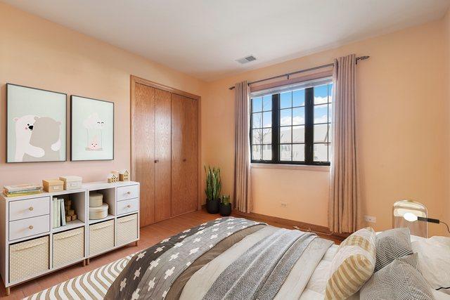 11545 Autobahn Dr E Unit 101, Palos Park, IL 60464 - bedroom with wood finished floors, a closet, and baseboards