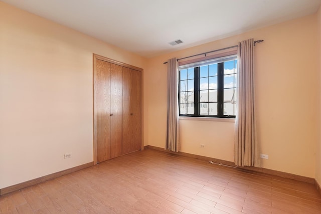 11545 Autobahn Dr E Unit 101, Palos Park, IL 60464 - unfurnished bedroom with light wood finished floors, a closet, and baseboards