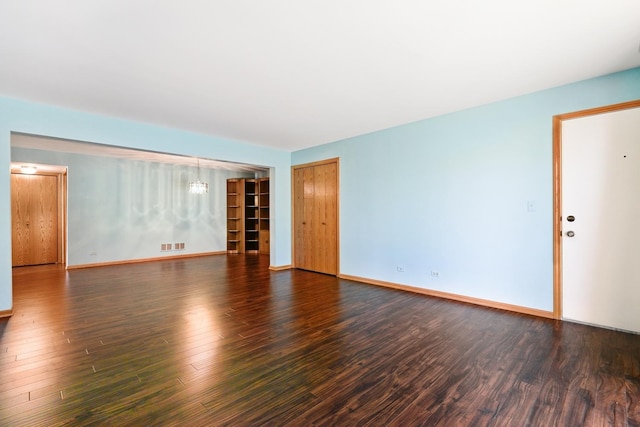 11545 Autobahn Dr E Unit 101, Palos Park, IL 60464 - spare room with wood finished floors, baseboards, and a chandelier