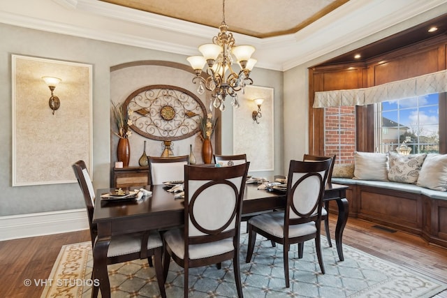 22957 Devonshire Ln, Frankfort, IL 60423 - dining room with a chandelier, wood finished floors, crown molding, baseboards, and a raised ceiling
