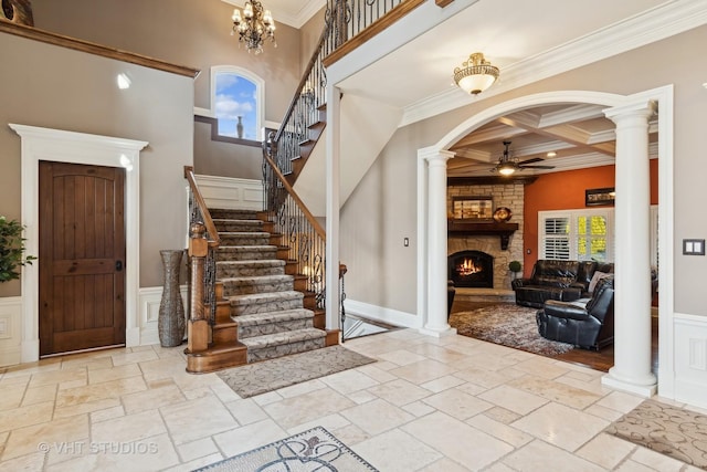 22957 Devonshire Ln, Frankfort, IL 60423 - foyer featuring ceiling fan, a stone fireplace, coffered ceiling, crown molding, and stairway