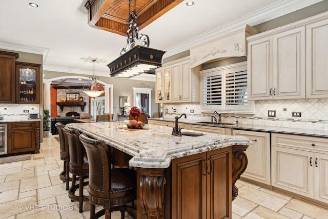 22957 Devonshire Ln, Frankfort, IL 60423 - kitchen with cream cabinetry, a sink, stone tile flooring, ornamental molding, and backsplash