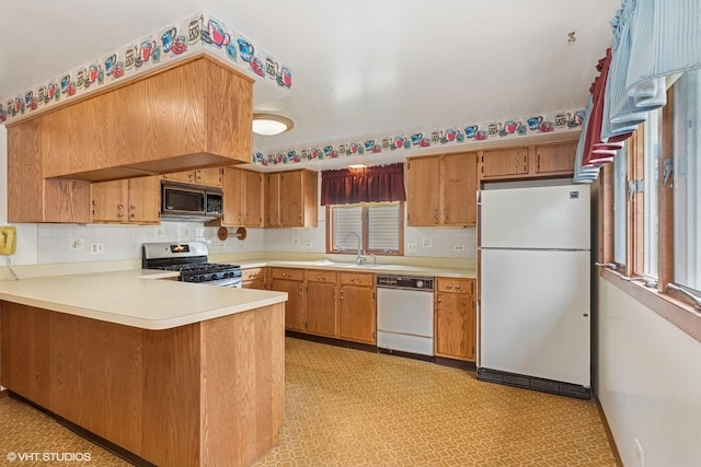 427 Lawrence Ave, Grayslake, IL 60030 - kitchen with white appliances, a peninsula, light countertops, and tasteful backsplash