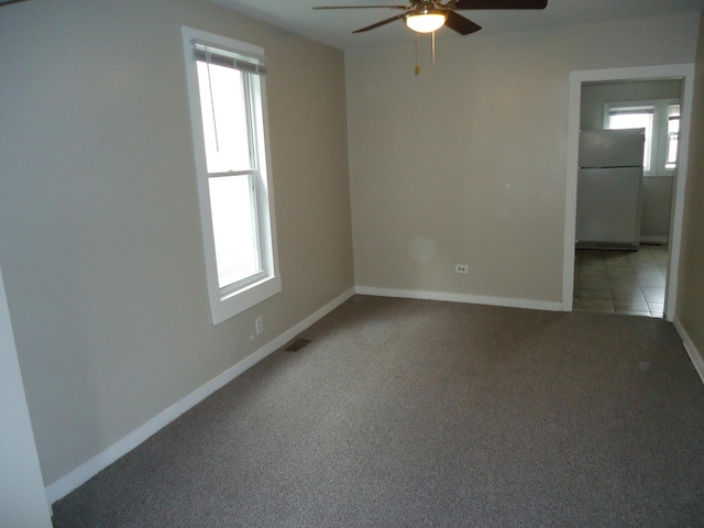 12438 Maple Ave, Blue Island, IL 60406 - empty room featuring ceiling fan, light colored carpet, and baseboards
