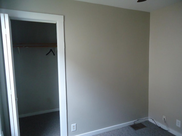 12438 Maple Ave, Blue Island, IL 60406 - unfurnished bedroom with baseboards and dark colored carpet