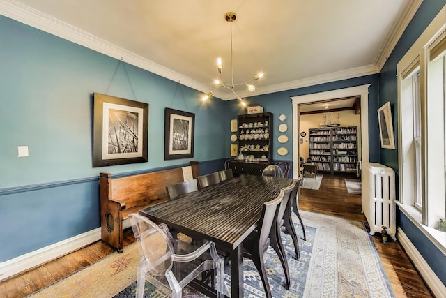 1701 W Chase Ave, Chicago, IL 60626 - dining space with radiator heating unit, wood finished floors, crown molding, and baseboards