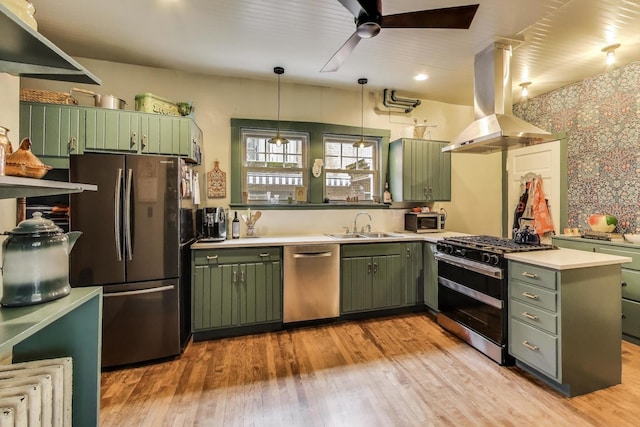 1701 W Chase Ave, Chicago, IL 60626 - kitchen featuring green cabinets, stainless steel appliances, island range hood, a ceiling fan, and a sink