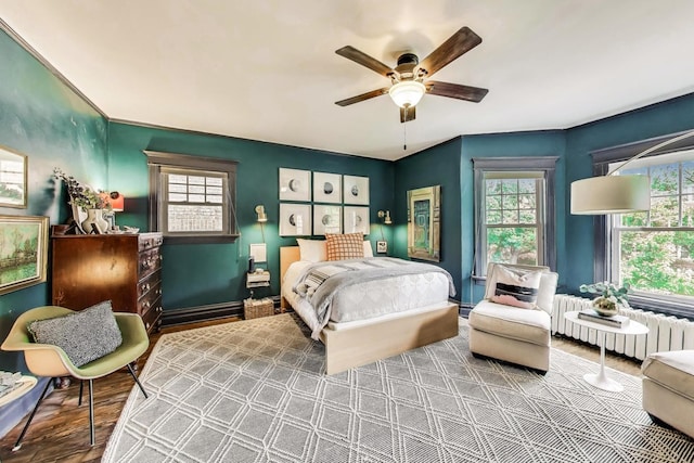 1701 W Chase Ave, Chicago, IL 60626 - bedroom with radiator heating unit, multiple windows, wood finished floors, ceiling fan, and crown molding