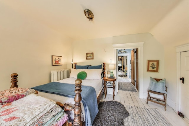 1701 W Chase Ave, Chicago, IL 60626 - bedroom with radiator, light wood-type flooring, and vaulted ceiling
