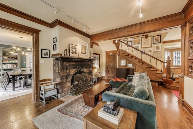 1701 W Chase Ave, Chicago, IL 60626 - living room featuring track lighting, a fireplace, stairway, hardwood / wood-style floors, and radiator