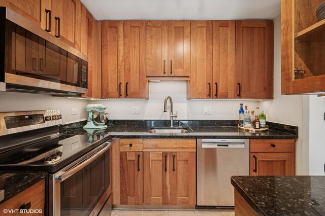 450 W Briar Pl Unit 12G, Chicago, IL 60657 - kitchen featuring appliances with stainless steel finishes, a sink, and brown cabinetry