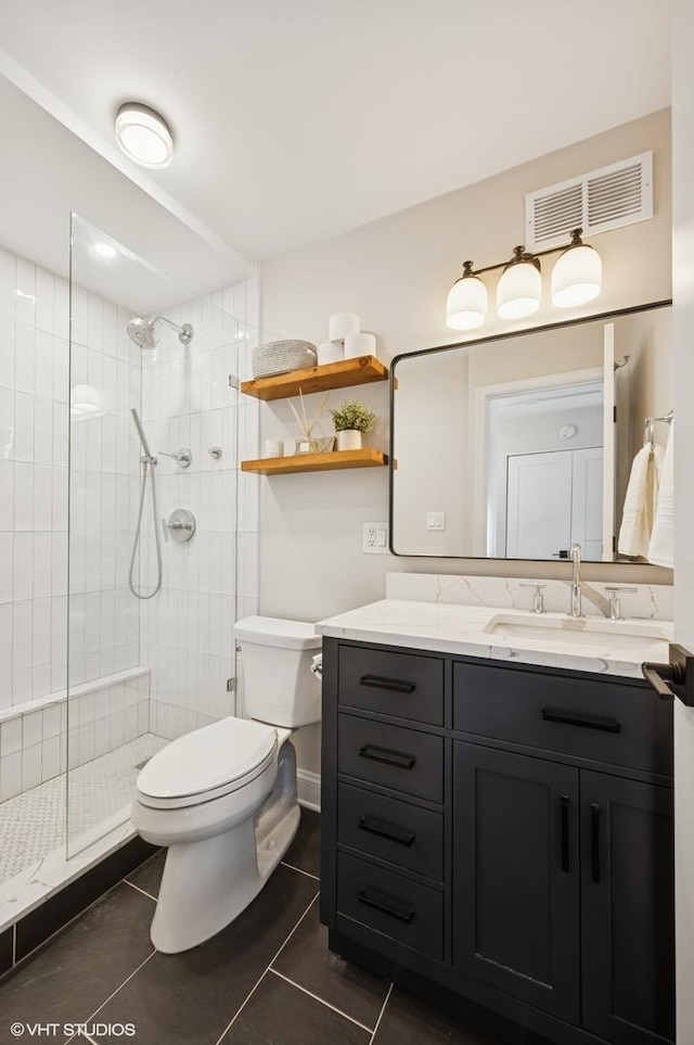450 W Briar Pl Unit 12G, Chicago, IL 60657 - full bathroom with toilet, tile patterned flooring, vanity, and a tile shower