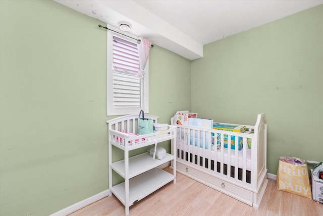 3034 S Komensky Ave, Chicago, IL 60623 - bedroom with wood finished floors, a nursery area, and baseboards