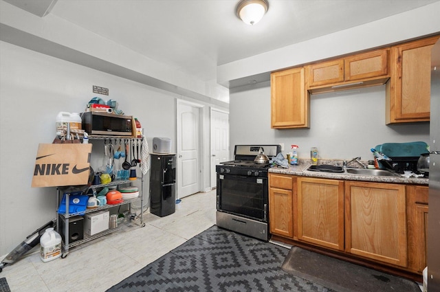 3034 S Komensky Ave, Chicago, IL 60623 - kitchen featuring stainless steel appliances, a sink, light tile patterned floors, and brown cabinets