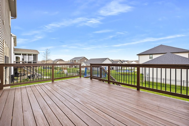 2708 Red Rock Rd, Normal, IL 61761 - deck featuring a residential view, a sunroom, and a fenced backyard