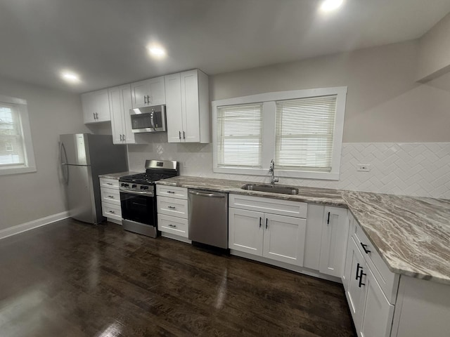 12424 S Carpenter St, Calumet Park, IL 60827 - kitchen featuring appliances with stainless steel finishes, a sink, tasteful backsplash, light stone counters, and recessed lighting