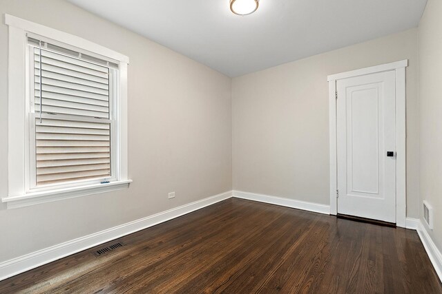 12424 S Carpenter St, Calumet Park, IL 60827 - empty room with dark wood-style flooring and baseboards