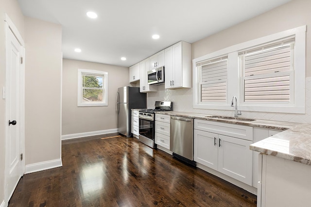 12424 S Carpenter St, Calumet Park, IL 60827 - kitchen featuring appliances with stainless steel finishes, a sink, light stone countertops, decorative backsplash, and white cabinetry