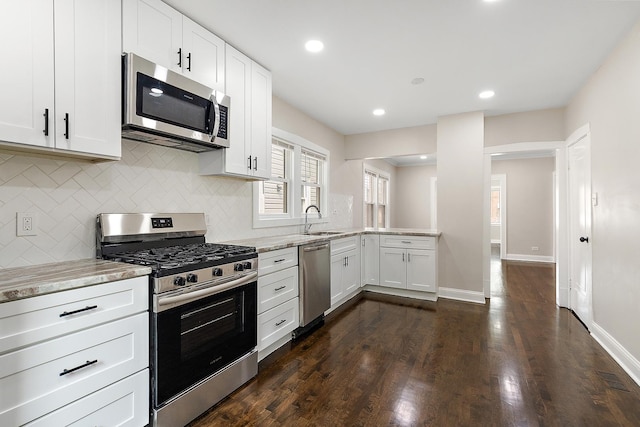 12424 S Carpenter St, Calumet Park, IL 60827 - kitchen featuring appliances with stainless steel finishes, a sink, backsplash, light stone countertops, and white cabinets