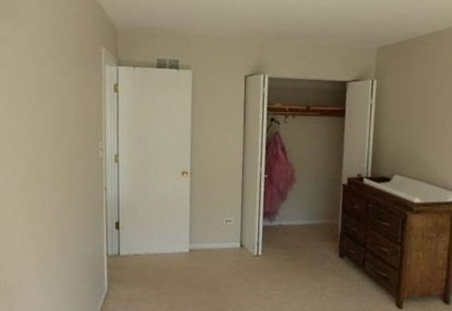 7254 Terrace Dr Unit 47, Justice, IL 60458 - bedroom with a closet, light carpet, and baseboards