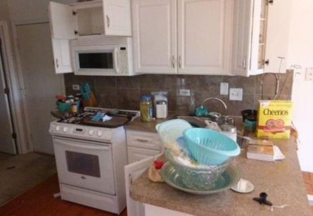 7254 Terrace Dr Unit 47, Justice, IL 60458 - kitchen featuring white appliances, white cabinets, and decorative backsplash