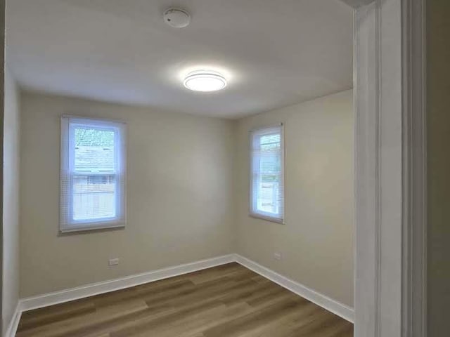2524 Gray Ct, Waukegan, IL 60085 - spare room with plenty of natural light, baseboards, and dark wood-style flooring