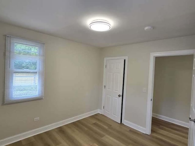 2524 Gray Ct, Waukegan, IL 60085 - unfurnished bedroom with dark wood-type flooring and baseboards