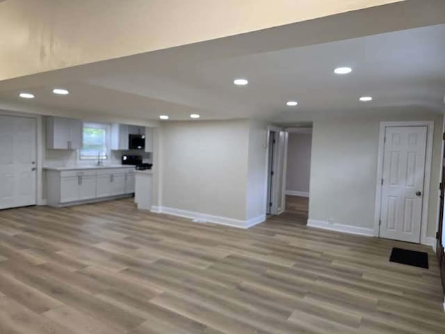 2524 Gray Ct, Waukegan, IL 60085 - unfurnished living room featuring recessed lighting, baseboards, and light wood-style floors
