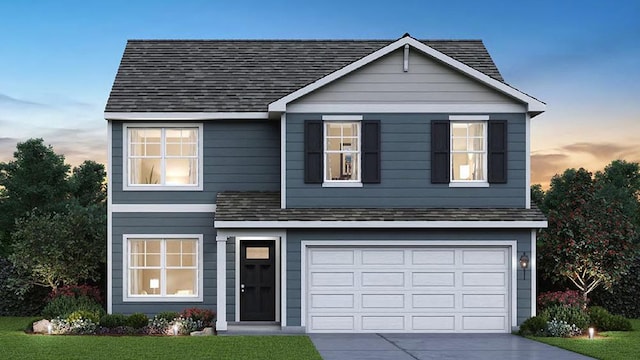traditional-style house with concrete driveway, a shingled roof, a garage, and a lawn
