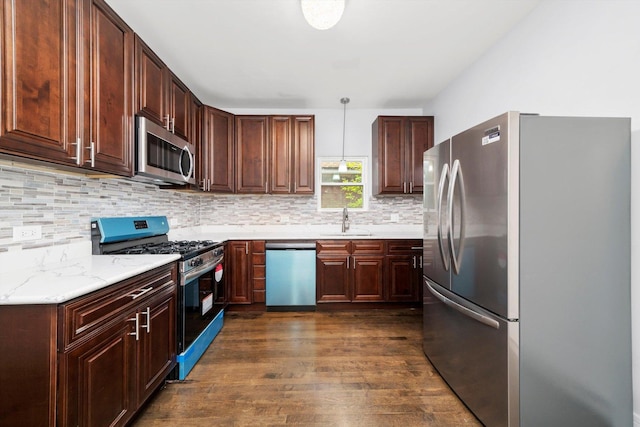 11522 S Parnell Ave, Chicago, IL 60628 - kitchen featuring appliances with stainless steel finishes, a sink, dark wood-type flooring, decorative backsplash, and pendant lighting