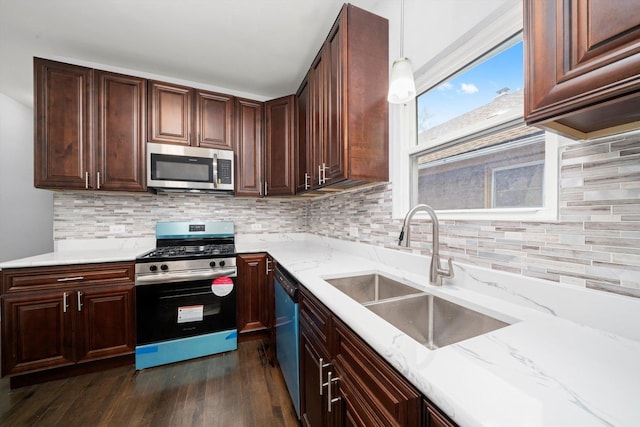 11522 S Parnell Ave, Chicago, IL 60628 - kitchen featuring appliances with stainless steel finishes, a sink, dark wood-type flooring, light stone countertops, and decorative backsplash