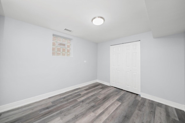 11522 S Parnell Ave, Chicago, IL 60628 - unfurnished bedroom with wood finished floors, baseboards, and a closet