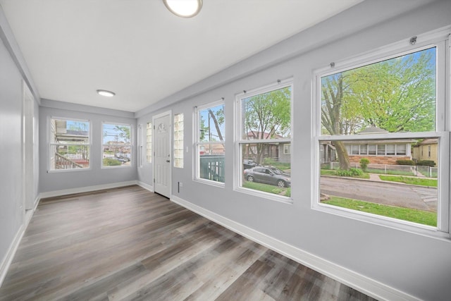 11522 S Parnell Ave, Chicago, IL 60628 - unfurnished sunroom featuring baseboards and wood finished floors