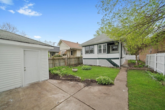 11522 S Parnell Ave, Chicago, IL 60628 - rear view of house with a patio and a shingled roof