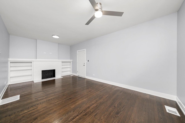 11522 S Parnell Ave, Chicago, IL 60628 - unfurnished living room featuring baseboards, ceiling fan, dark wood-type flooring, a fireplace, and built in features