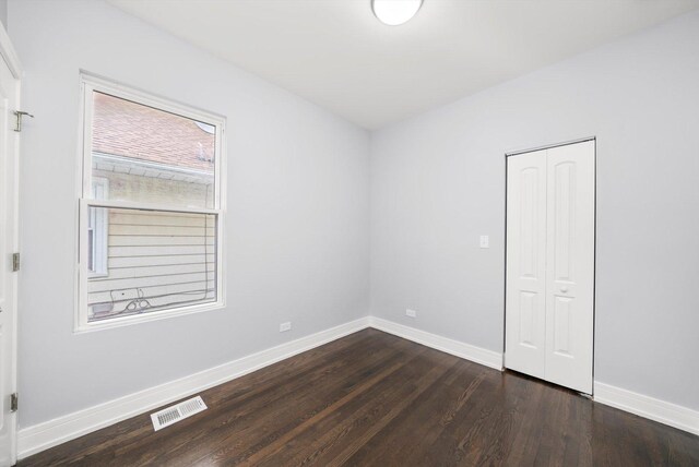 11522 S Parnell Ave, Chicago, IL 60628 - spare room featuring dark wood-type flooring and baseboards