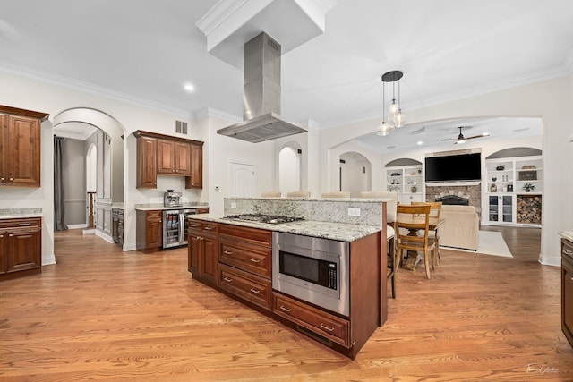 4103 Douglas Rd, Downers Grove, IL 60515 - kitchen featuring stainless steel appliances, island exhaust hood, wine cooler, arched walkways, and a ceiling fan