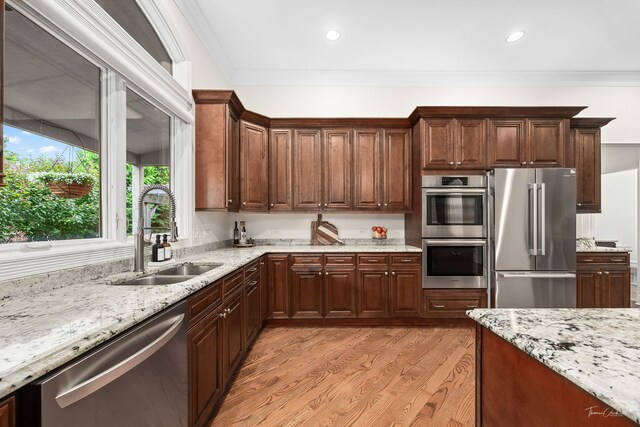 4103 Douglas Rd, Downers Grove, IL 60515 - kitchen featuring stainless steel appliances, light stone counters, light wood-type flooring, crown molding, and recessed lighting