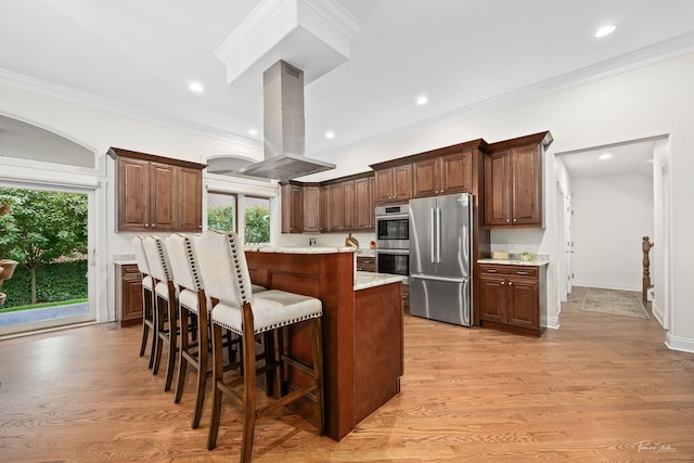 4103 Douglas Rd, Downers Grove, IL 60515 - kitchen featuring stainless steel appliances, island range hood, a center island, a kitchen breakfast bar, and plenty of natural light