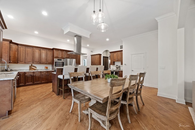 4103 Douglas Rd, Downers Grove, IL 60515 - dining area featuring light wood finished floors, ornamental molding, beverage cooler, recessed lighting, and arched walkways
