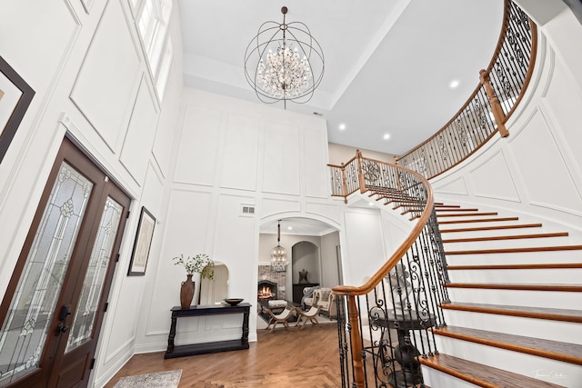 4103 Douglas Rd, Downers Grove, IL 60515 - entrance foyer with a high ceiling, a chandelier, stairs, a decorative wall, and recessed lighting