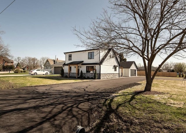 9859 S 81st Ave, Palos Hills, IL 60465 - modern farmhouse style home featuring stone siding, board and batten siding, a detached garage, and driveway