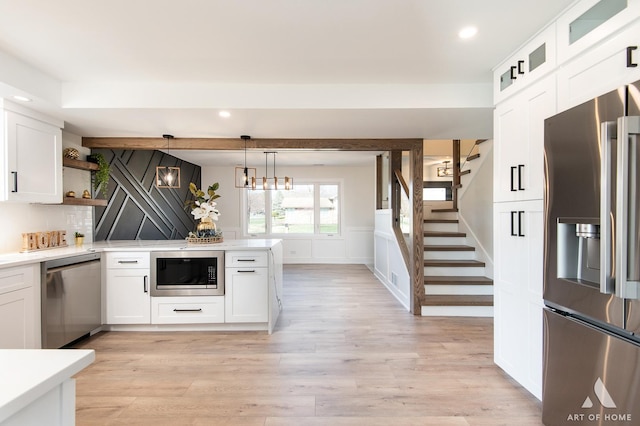9859 S 81st Ave, Palos Hills, IL 60465 - kitchen featuring stainless steel appliances, white cabinets, light countertops, recessed lighting, and a decorative wall